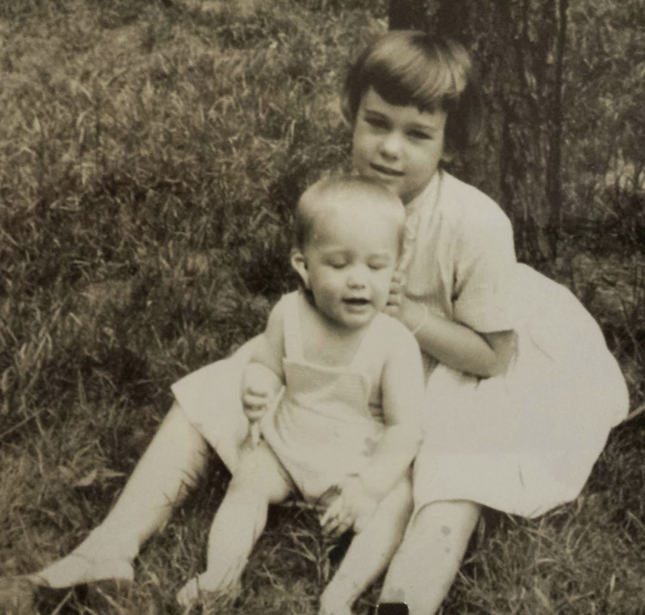 Young Liza holding her baby sibling