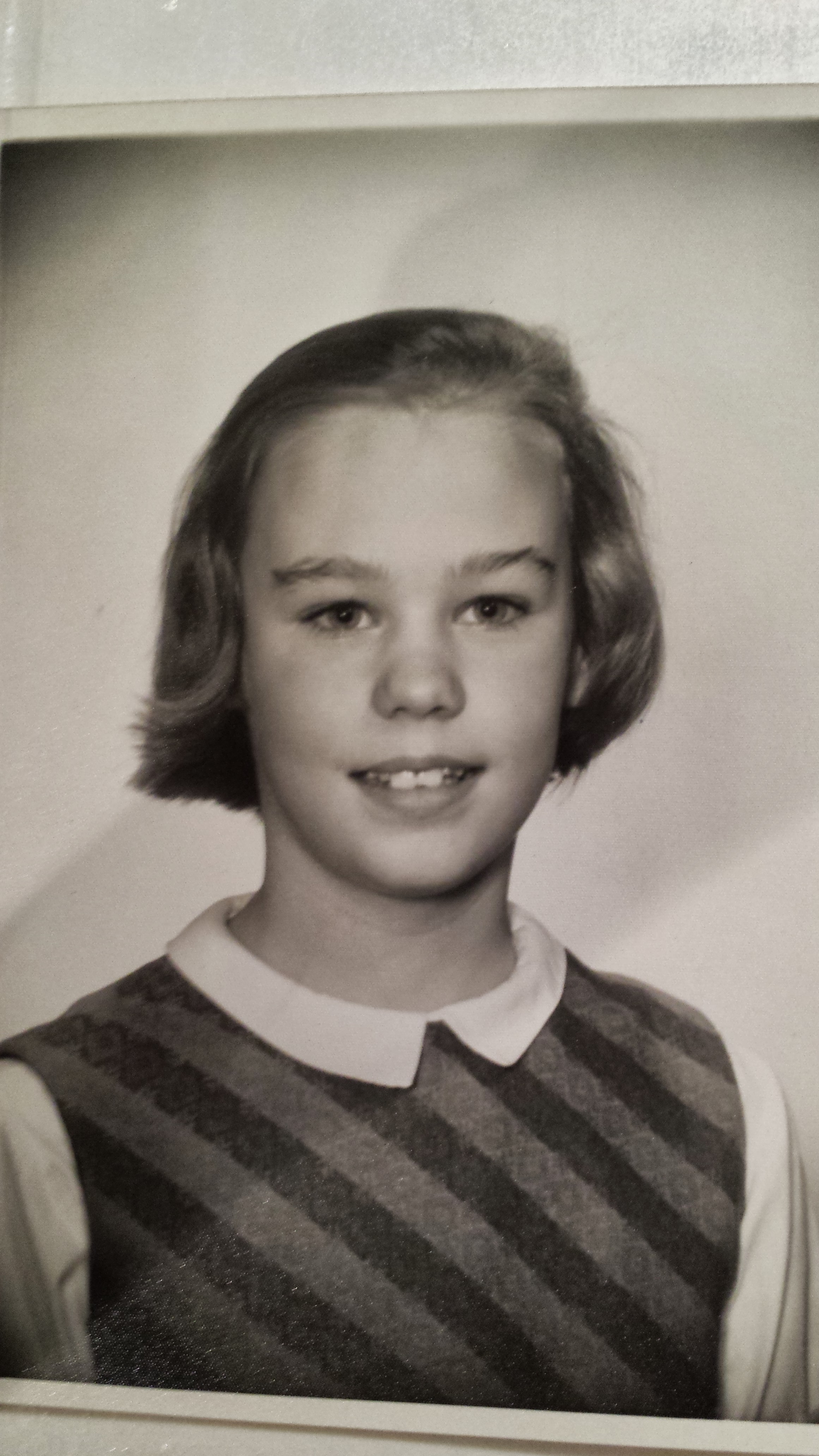 Liza's school portrait in a striped dress