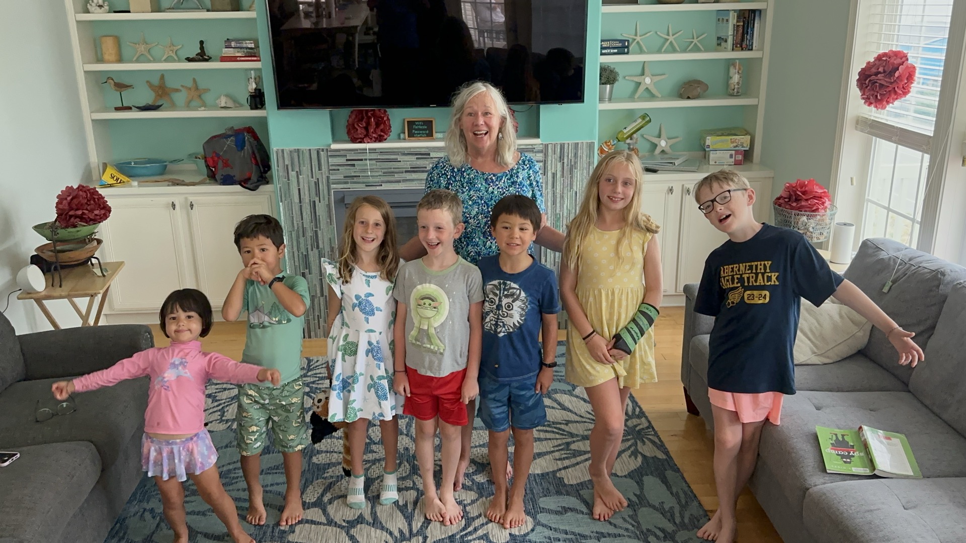 Elizabeth surrounded by her grandchildren, all smiling together