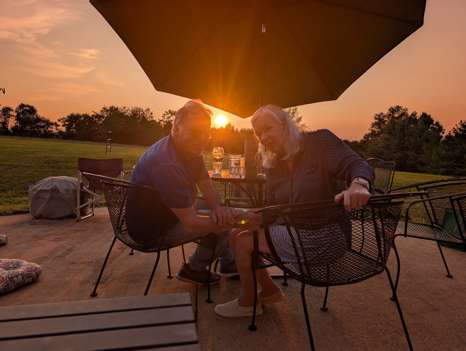 Elizabeth Haywood enjoying a beautiful sunset with a cocktail in hand